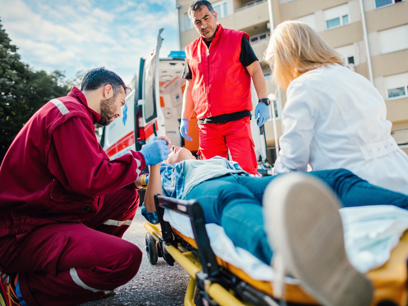 Medical emergency team helping injured woman